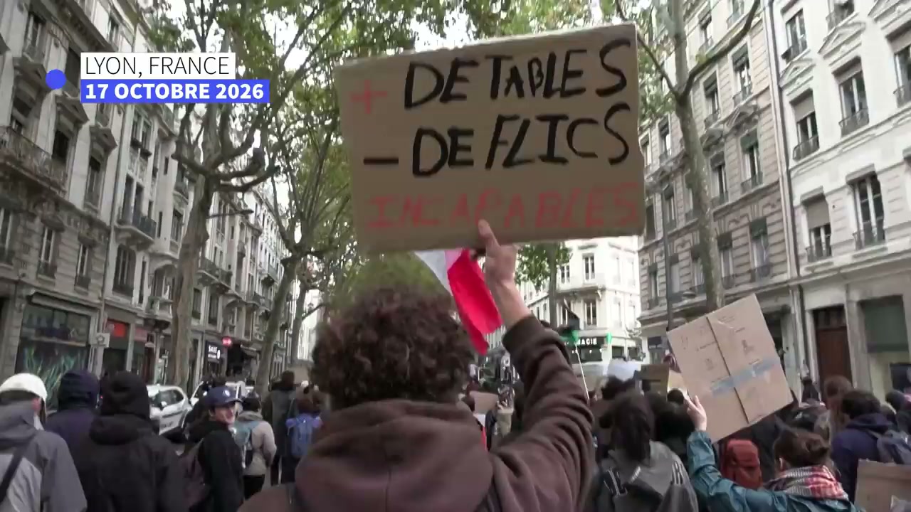 A marcher in Lyon holds a sign calling for more tables and fewer police, with AFP’s October 17 date label visible