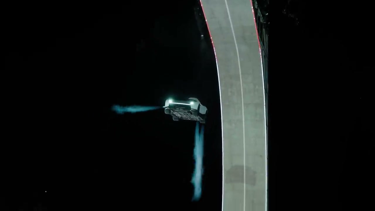 The Roadster airborne beside the ramp, with visible plumes extending from the car
